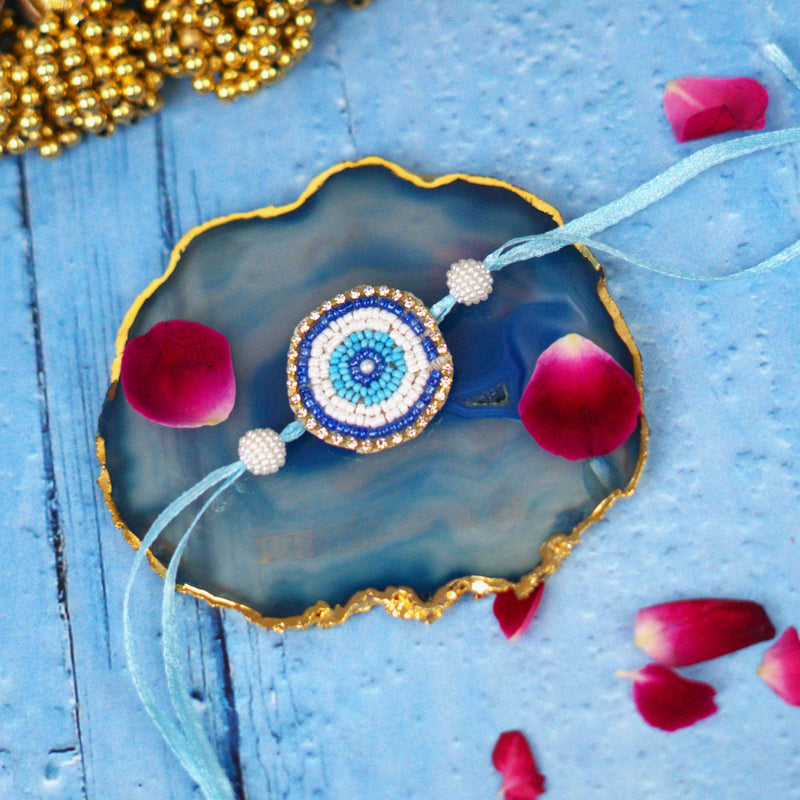 Handcrafted Evil Eye Beaded Rakhi with Dual Panel Design and Satin Thread and Pearl Accents