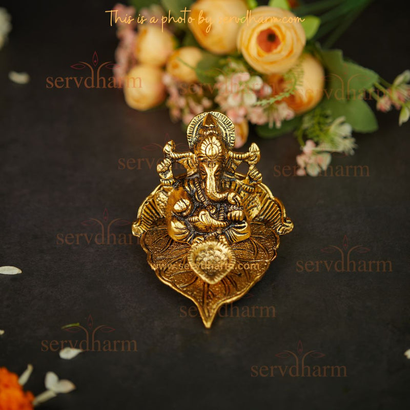 Ganesha/Ganpati And Diya On Leaf In Gold Finish